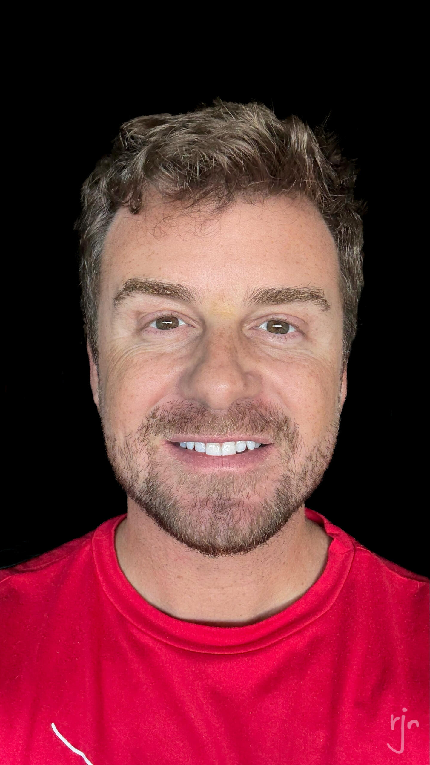 Ryan Negri, smiling, in a red shirt